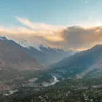 Hunza Valley in the foreground and the snow clad Rakaposhi mountain in background during golden hour