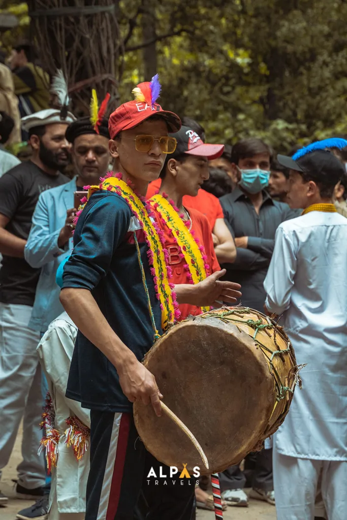 A teenager beating the drum at the festival